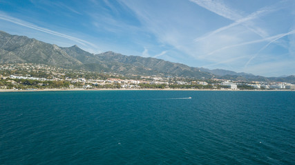 Obraz premium amazing day of navigation in front of marbella coast, malaga, south of spain. View from the sea while sailing