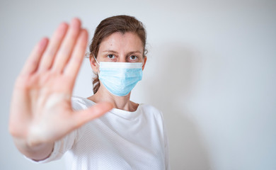 stop coronavirus woman wearing medical mask and raising hand 2019-nCoV fight - spreading
