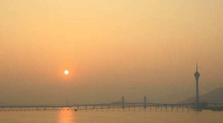 Sunset view of the Governador Nobre de Carvalho Bridge with the Macau Tower Convention and...