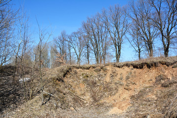 Water erosion remove  soil material from hill by water.