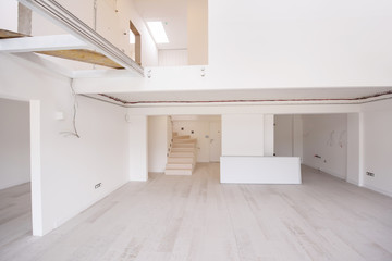 Interior of empty stylish modern open space two level apartment