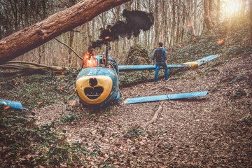 petit avion en flamme  tombé dans un bois avec un survivant