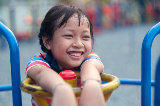 Happy Asian Little Child Girl On Playground