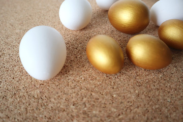 Golden and white eggs lie on the table. Happy easter concept, copy space.