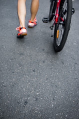 Blur Image of a Person with Bike on the Street Walking Away - can be used as background