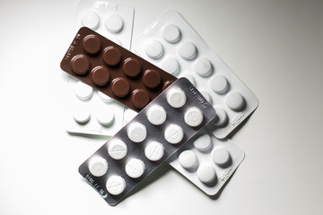 pills in plates on a white background