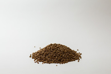 heap of buckwheat on a white background