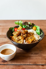 Steam rice with Chicken Satay and fried egg served with a salad including green oak and tomato. Served with Satay sauce.