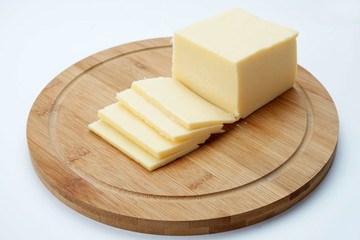Cheese on a cutting Board isolated on a light background