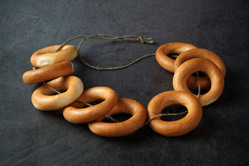 A bunch of baked bagels on a rope