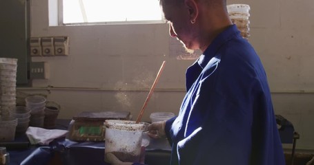 Mixed race man working in factory - Powered by Adobe