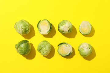 Flat lay with brussels sprout on yellow background, top view