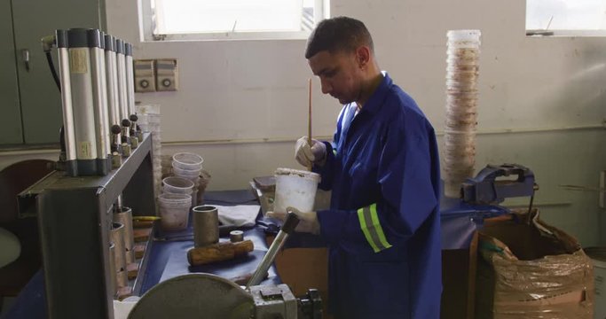 Mixed race man working in factory