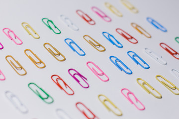 multicolored paper clips on a white background