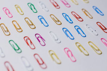 multicolored paper clips on a white background