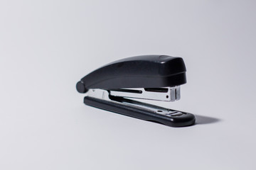 black stapler on a white background