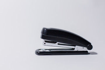 black stapler on a white background