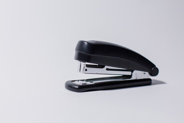 black stapler on a white background
