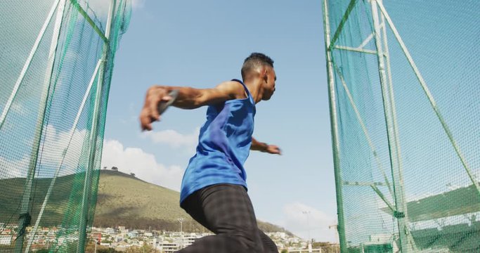 Mixed race athlete doing discus throw