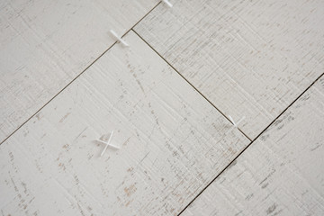 Ceramic wood effect tiles and tools for tiler on the floor