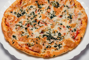 Delicious Italian pizza with olives and greens on a light background top view
