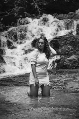 Portrait of a young woman in the waterfall