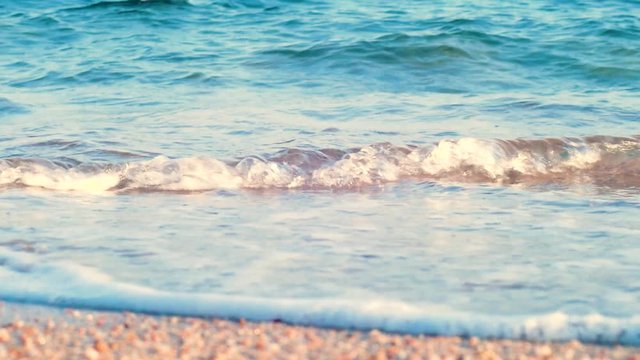 Sea waves on the beach close up. Stock video buy. Clear blue water with sand