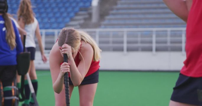 Female hockey players sad after a match 