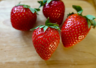 A lot of ripe strawberries on a wooden table