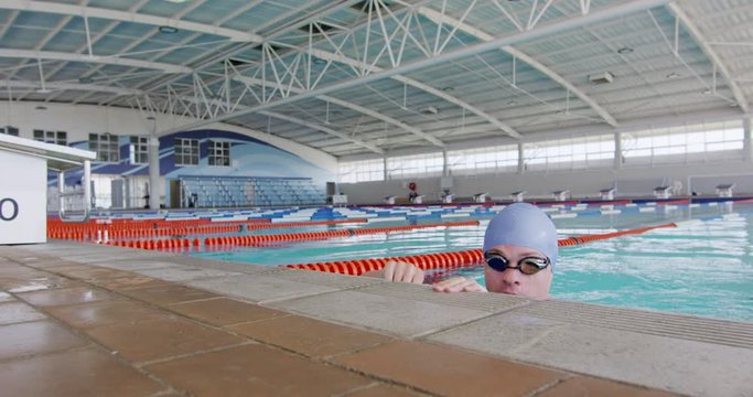 Swimmer coming out of water and looking at camera
