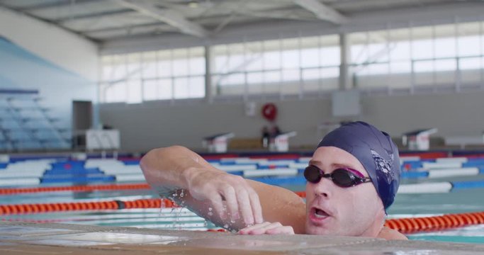 Swimmer Coming Out Of Water And Looking At Camera