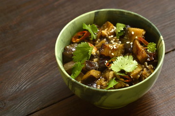 Fried eggplant with garlic, cilantro in ginger and soy sauce, copy space