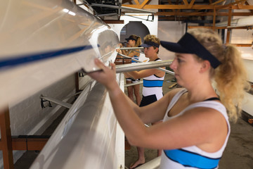 Female rowing team training on a river