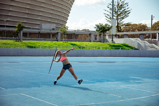 Athlete Throwing A Javelin At The Stadium