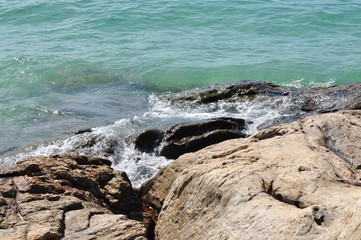 Sea water with waves and rocks at the beach