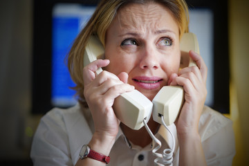 Face of office woman in stress with a lot of phone calls at same time. Busy office worker female...