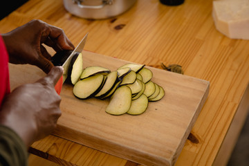 African man cutting an eggplant