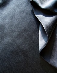 Black silk fabric with drapery. The texture of the fabric. Natural silk. Silk scarf, silk scarf.