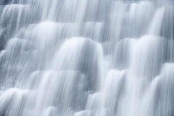Close up of water flowing down a dam wall after heavy rain fall