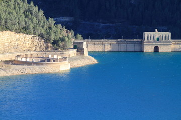 dam and drain with blue bright water