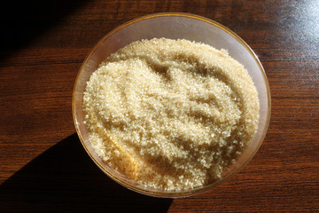 Cane sugar in glass bowl on table