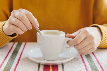 Stock photo of the hands of a girl holding a cup