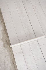 Ceramic wood effect tiles and tools for tiler on the floor