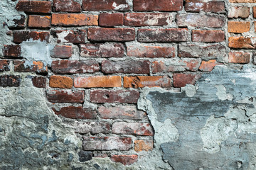 Dilapidated red brick wall, old ruined facade. Urban grunge stonewall, destroyed building, cement architecture background.