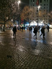 people walking on the street at night