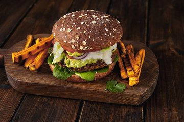 Bright and healthy lentils burger on dark rustic background