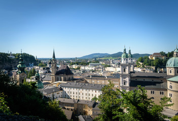 Fototapeta premium The Franciscan Church, Salzburg Cathedral and Stift St. Peter Salzburg in Salzburg over the banks of Salzach river as seen from Fortress Hohensalzburg