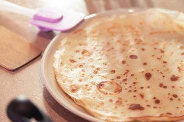 A fresh pancakes on a plate close up.