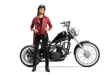Fototapeta na wymiar Young female biker posing with a custom motorbike