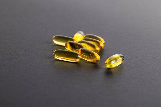 Omega-3 fish oil gel cap pills containing fatty acids, eicosapentaenoic acid and docosahexaenoic acid, precursors of certain eicosanoids